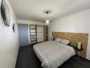a bedroom with a large bed in a room at Appartement à Vouglans in Lect