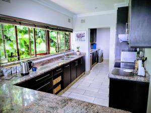 a kitchen with a large sink and a large window at Lagoon Lodge in Freeland Park