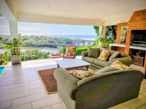 a living room with couches and a view of a river at Lagoon Lodge in Freeland Park