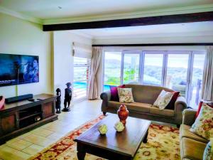 a living room with a couch and a table at Lagoon Lodge in Freeland Park