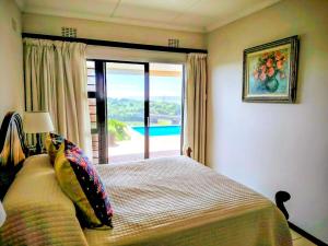 a bedroom with a bed with a view of a pool at Lagoon Lodge in Freeland Park +32 photos