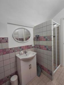 a bathroom with a sink and a mirror at Lacerno Rooms in Pescosolido +32 photos
