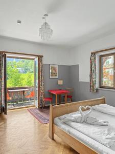 a bedroom with a bed and a red table at Landhaus Schönblick in Bad Kohlgrub
