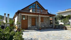 a house with a balcony on top of it at Vila Ramaj in Berat
