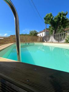 a large swimming pool with a wooden fence at La Casettina della Cantina in Prasco +15 photos