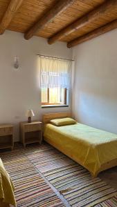 a bedroom with a bed and a window at Vila Ramaj in Berat