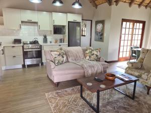a living room with a couch and a coffee table at Otters Den in Nottingham Road