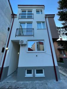 a white building with windows and a balcony at BD Luxury Apartment in Bitola