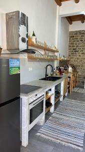 a kitchen with a sink and a stove at Vila Ramaj in Berat +22 photos