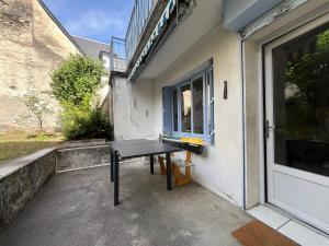 a table sitting outside of a building with a window at Maison CALI LUZ in Luz-Saint-Sauveur +6 photos