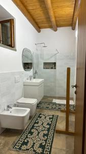 a white bathroom with a sink and a toilet at Vila Ramaj in Berat