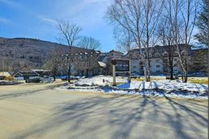 an empty street with a sign in the snow at Mountainview Condo at Rivergreen in Lincoln