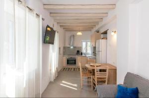a kitchen and dining room with a table and chairs at Xenia Xinara in Tinos