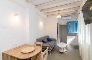 a living room with a table and a couch at Xenia Xinara in Tinos