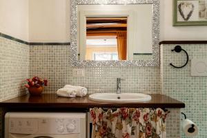 a bathroom with a sink and a mirror at Appartamento Caretto in Baveno