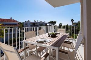 a wooden table and chairs on a balcony at PJ Properties Riviera Escape Suite Sounio in Sounio
