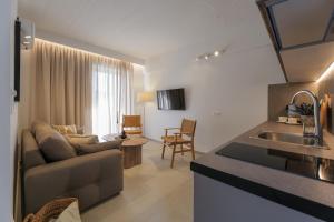 a kitchen and living room with a couch and a sink at PJ Properties Riviera Escape Suite Sounio in Sounio