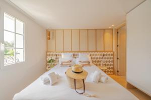 a bedroom with a bed with a straw hat on it at Lou Saint-Tropez in Saint-Tropez +56 photos