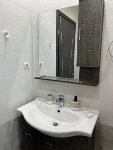 a bathroom with a white sink and a mirror at Amare casa in Perivólia +35 photos
