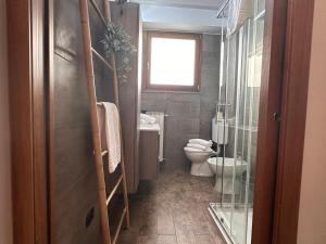 a bathroom with a toilet and a window at The Hangar Loft - Leonoardo, Center & Parking in Sesto Calende +25 photos