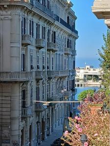 a white building with a balcony on the side of it at Guesthouse City Center in Bari