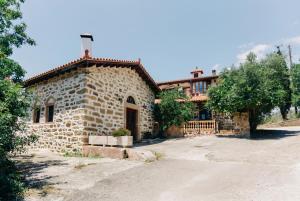a stone house with a driveway in front of it at Rustic Kampos House Retreat in Chios