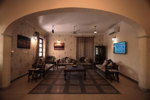 a living room with couches and a table at Rangmahal Pushkar by DIV HOSPITALITY in Pushkar