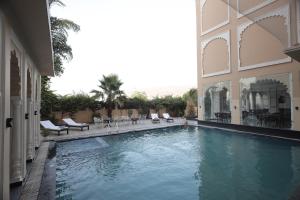 a swimming pool in the middle of a building at Rangmahal Pushkar by DIV HOSPITALITY in Pushkar