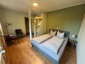 a bedroom with a bed and a bunk bed with a ladder at Gasthaus Schwielochsee in Friedland