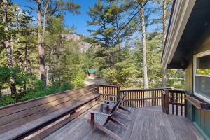 a bench sitting on the deck of a house at 7 Merrimeeting Chalet in Conway