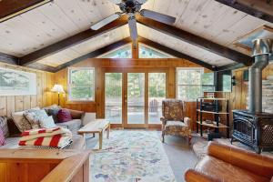 a living room with a couch and a ceiling fan at 7 Merrimeeting Chalet in Conway