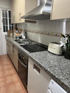 a kitchen with a sink and a counter top at Casa Quijote in La Herradura