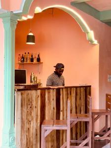 a man sitting at a bar in a restaurant at Laughing Leopard Trinco in Trincomalee +12 photos