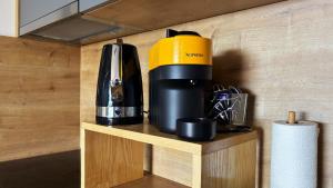 a coffee maker on a shelf in a room at Mobile Home SkyLine - beautiful sea view - on the palm of the beach in Drage