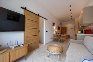 a living room with a couch and a table at Asini deluxe suite 4, with rooftop terrace and breathtaking views in Asíni