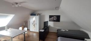 a living room with a table and a horse picture on the wall at Messe Apartment BIN in Hildesheim