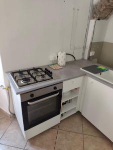 a kitchen with a stove top oven in a kitchen at Appartamento in Corte Storica in Alzano Lombardo
