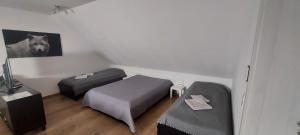 a room with two beds and a dog picture on the wall at Messe Apartment BIN in Hildesheim