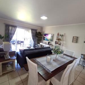a living room with a table and a couch at Heaven at Sea in Mossel Bay