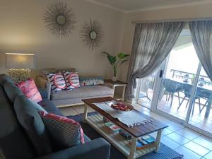 a living room with a couch and a table at Heaven at Sea in Mossel Bay