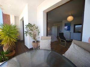 a room with a glass table and a living room at Vistas de Ronda in Ronda