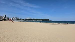 a beach with a person flying a kite at Ocean House PH in Pohang