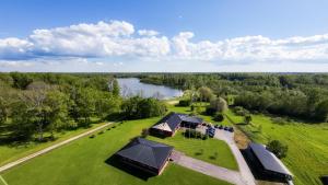 an overhead view of a house on a field with a lake at Eistvere Puhkemaja in Eistvere