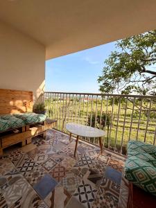 a balcony with a table and a view of a field at Priestranný apartmán s veľkorysým výhľadom in Rača
