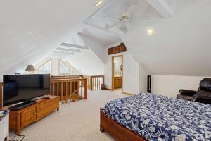 a bedroom with a bed and a flat screen tv at Eidelweiss Retreat in Madison