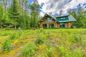 a log cabin in the middle of a field at Eaglet Log Home in Franconia