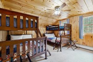 a bedroom with two bunk beds and a crib at Garfield's Grand View in Bethlehem