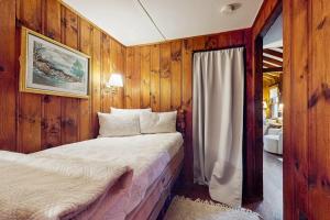 a bedroom with wooden walls and a bed in a room at Rustic Rockport Cottage in Rockport