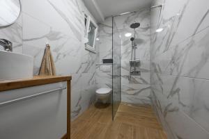 a bathroom with a glass shower and a toilet at Apartment Sanja in Zadar +45 photos