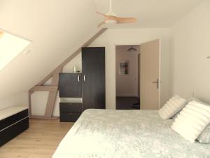 a bedroom with a bed and a ceiling fan at Chambre d'hôte Monthorin in Vernie